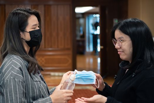 Asian women wearing mask and alcohol antibacterial hand gel respiratory protection mask against epidemic flu covid19 or corona virus with fear emotion in concept illness, outbreak, healthcare in life