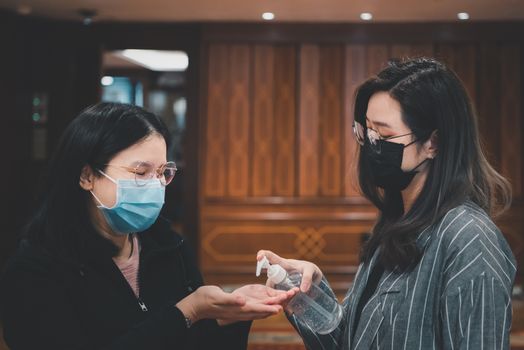 Asian women wearing mask and alcohol antibacterial hand gel respiratory protection mask against epidemic flu covid19 or corona virus with fear emotion in concept illness, outbreak, healthcare in life