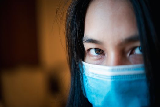 Asian pretty woman wearing mask respiratory protection mask against epidemic flu covid19 or corona virus from wuhan in office with fear emotion in concept illness, outbreak, healthcare in life