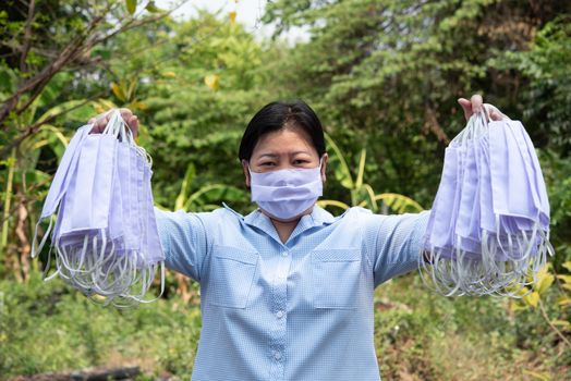 Asian pretty woman wearing mask respiratory protection mask against epidemic flu covid19 or corona virus from wuhan in office with fear emotion in concept illness, outbreak, healthcare in life