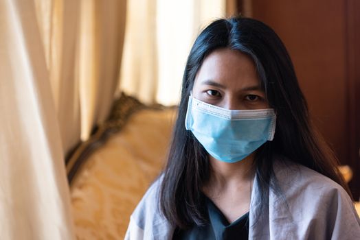 Asian pretty woman wearing mask respiratory protection mask against epidemic flu covid19 or corona virus from wuhan in office with fear emotion in concept illness, outbreak, healthcare in life