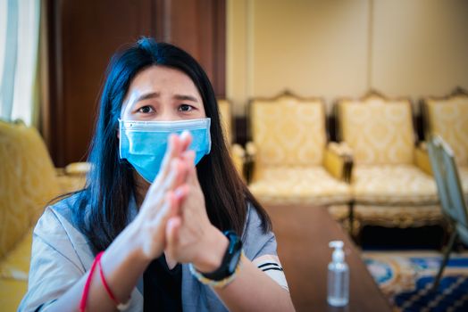 Asian woman wearing mask and alcohol antibacterial hand gel respiratory protection mask against epidemic flu covid19 or corona virus with fear emotion in concept illness, outbreak, healthcare in life