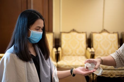 Asian woman wearing mask and alcohol antibacterial hand gel respiratory protection mask against epidemic flu covid19 or corona virus with fear emotion in concept illness, outbreak, healthcare in life