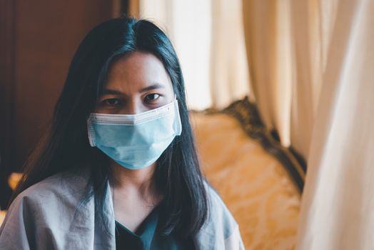 Asian pretty woman wearing mask respiratory protection mask against epidemic flu covid19 or corona virus from wuhan in office with fear emotion in concept illness, outbreak, healthcare in life