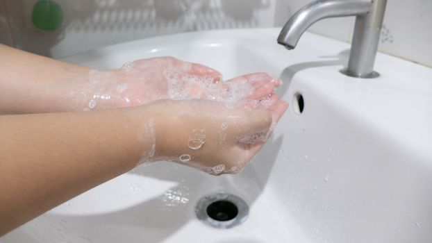 Closeup woman's hand washing