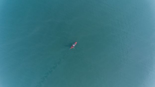 Aerial view of people with kayak over blue sea