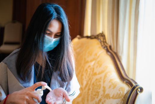 Asian woman wearing mask and alcohol antibacterial hand gel respiratory protection mask against epidemic flu covid19 or corona virus with fear emotion in concept illness, outbreak, healthcare in life