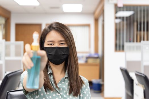 Asian woman wearing mask and alcohol antibacterial hand gel respiratory protection mask against epidemic flu covid19 or corona virus with fear emotion in concept illness, outbreak, healthcare in life