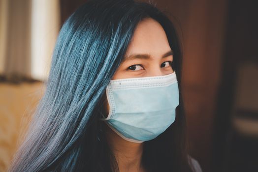 Asian pretty woman wearing mask respiratory protection mask against epidemic flu covid19 or corona virus from wuhan in office with fear emotion in concept illness, outbreak, healthcare in life