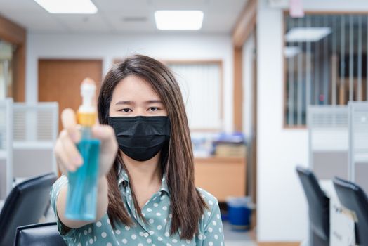 Asian woman wearing mask and alcohol antibacterial hand gel respiratory protection mask against epidemic flu covid19 or corona virus with fear emotion in concept illness, outbreak, healthcare in life