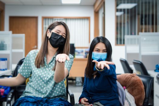 Asian pretty women wearing mask respiratory protection mask against epidemic flu covid19 or corona virus from wuhan in office with fear emotion in concept illness, outbreak, healthcare in life