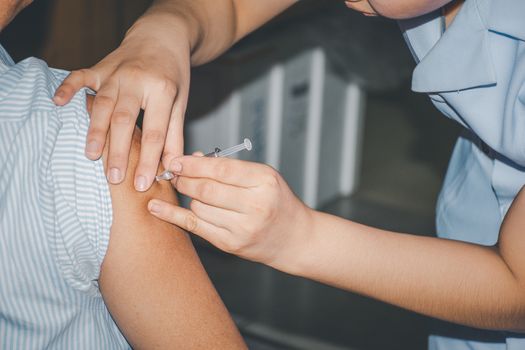 Patient asian woman health check by get vaccinated against the flu covid19 or corona virus every year by the Ministry of Health at hospital in concept illness, outbreak, healthcare in life