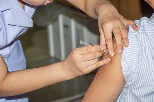 Patient asian woman health check by get vaccinated against the flu covid19 or corona virus every year by the Ministry of Health at hospital in concept illness, outbreak, healthcare in life