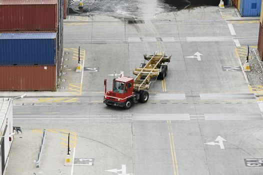 Cargo Containers Truck In Storage Area Of Freight Port Terminal