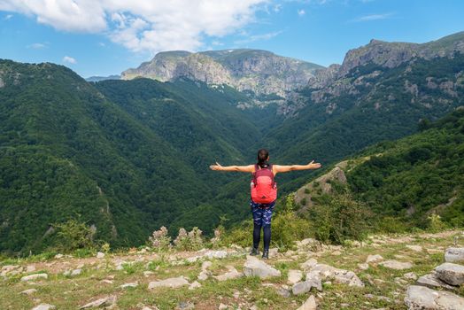 Lone active woman at the edge of the cliff, Central balkan, Bulgaria.