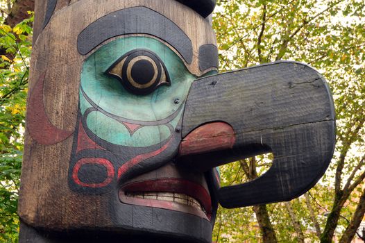 Details of a large wooden totem pole that dominates Pioneer Square in Seattle, Washington
