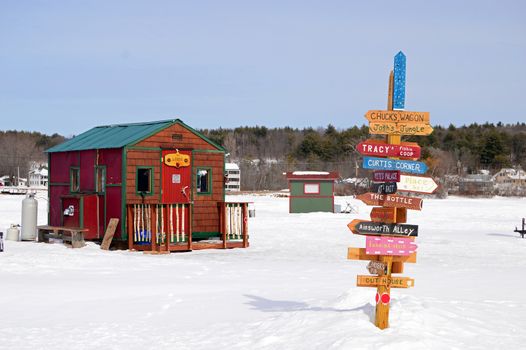 Signs point the way to a multitude of ice fishing shacks on Lake Winnipesaukee