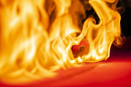 Billiard balls are photographed on fire while sitting outdoors in an open environment