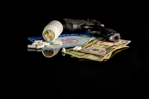 A bottle of pills on top of a blank social security card surrounded by American money