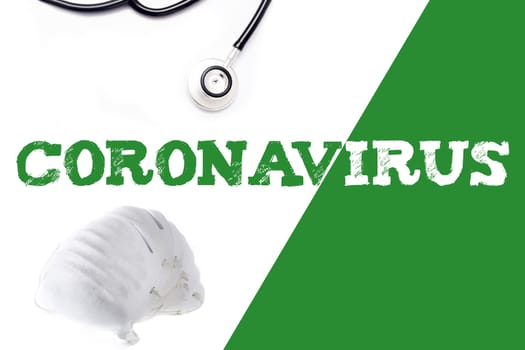 Coronavirus word, stethoscope and face mask on white and green background
