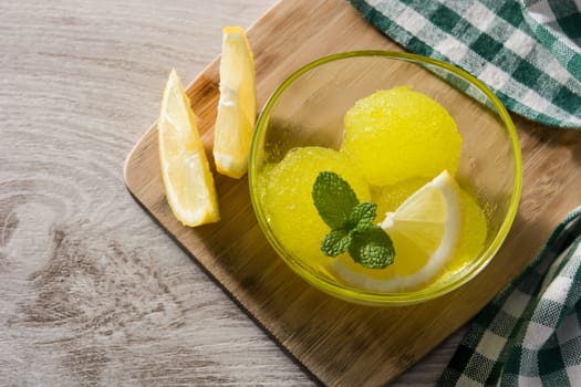 Lemon sorbet in glasses on white wooden background