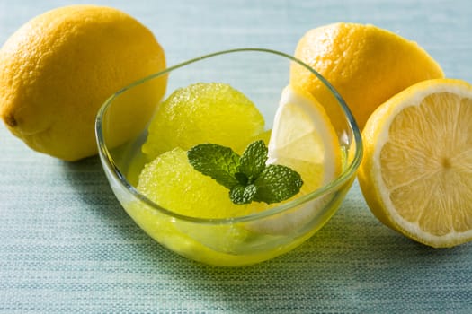 Lemon sorbet in glasses on blue background