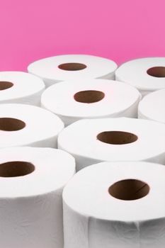 Toilet paper rolls isolated on pink background