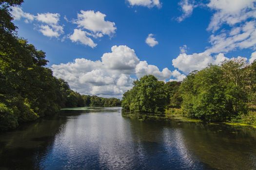 The English countryside during summer of a river and the surrounding reflections