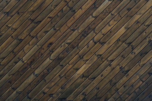 Wood Texture Background dark brown color 45 degree. texture of old wooden planks at an oblique angle. Diagonal background brown old wood planks
