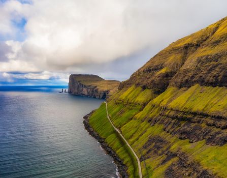 Aerial view over a bay with Risin and Kellingin sea stacks near the village of Tjornuvik on Faroe Islands.