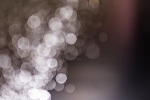 Abstract bokeh from light and water spray in backgrounds of various colors