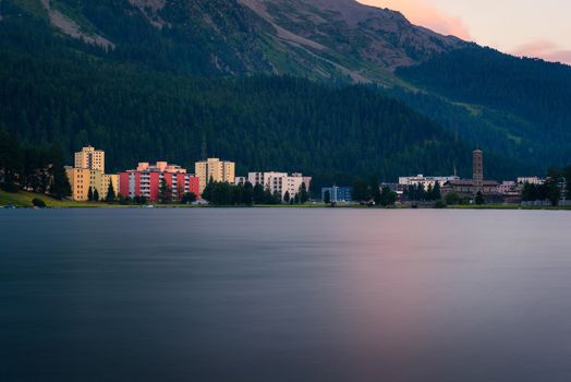 Sunset above St. Moritz with lake also called St. Moritzsee and Swiss Alps in the background in Engadin, Switzerland. Long exposure.