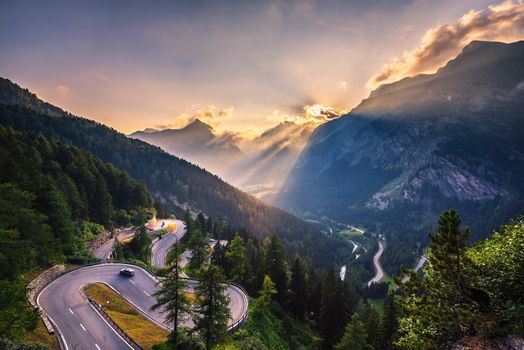 Aerial view of Maloja Pass road in Switzerland at sunset. This Swiss Alps mountain road is located in dense forests of the canton Graubunden. Hdr processed.