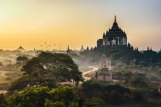 Scenic sunrise with hot air balloons aboveThatbyinnyu temple in Bagan, Myanmar. Bagan is an ancient city with thousands of historic buddhist temples and stupas.