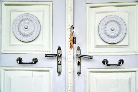 Wooden, antique door with metal door handles in the Czech Republic