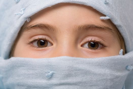 young girl with a veil covering her, close up, studio picture