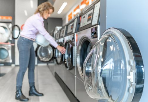 woman uses a public laundry