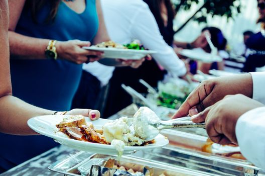 People eating from the wedding buffet