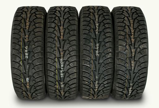 four winter tires isolated on white background