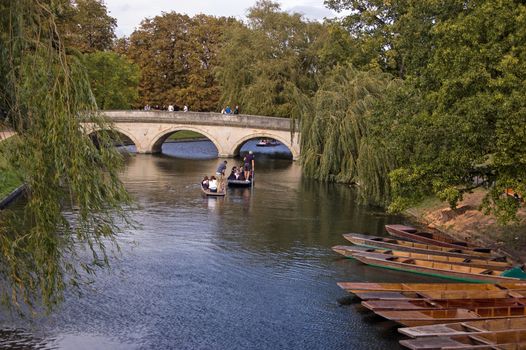 Cambridge, UK - September 19, 2011:  University students punting along the River Cam in Cambridge on September 19 2011. Competition to rent the small wooden boats has become particularly fierce.