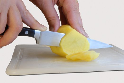 Hands of woman with a knife cut the vegetables