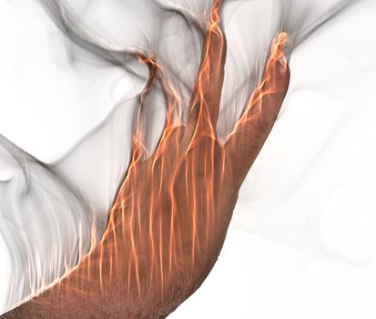 A human hand on fire burning with orange flames and some smoke in front of a white background