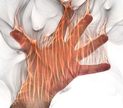 A human hand on fire burning with orange flames and some smoke in front of a white background