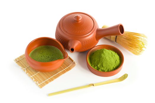 Matcha Green Tea and Japanese tea set. Ceramic teapot and a steaming cup Isolated on white background.