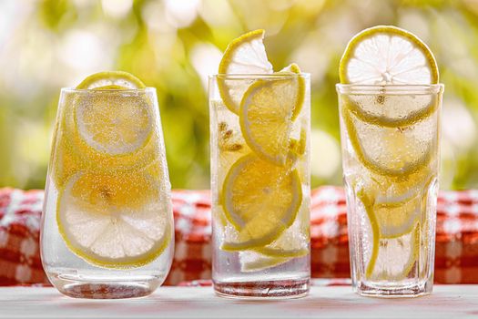 Citrus lemonade in garden setting, summer drink.