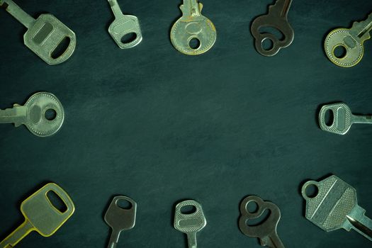 Different variety of vintage keys placed around in circular pattern on wooden background. Copy space in middle. Idea for keys to solving business problems to success. Concept for security or privacy.