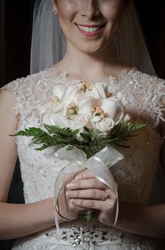 Bride with a bouquet of roses in hand