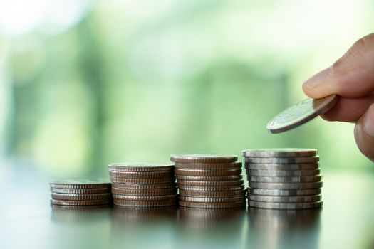 Business financial success concept. Gold coins on table and green nature bokeh background.Bullish market situation.