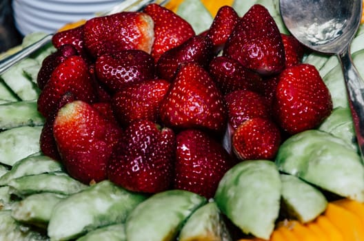 Table of salty snacks, strawberries and breads