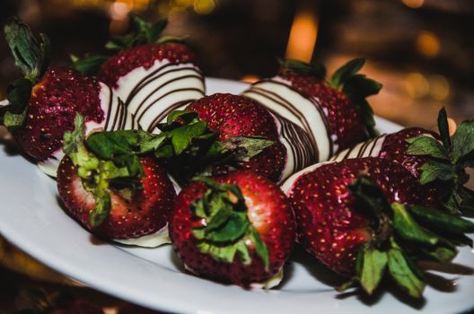 Strawberries with chocolate topping on the sweet table of a wedding